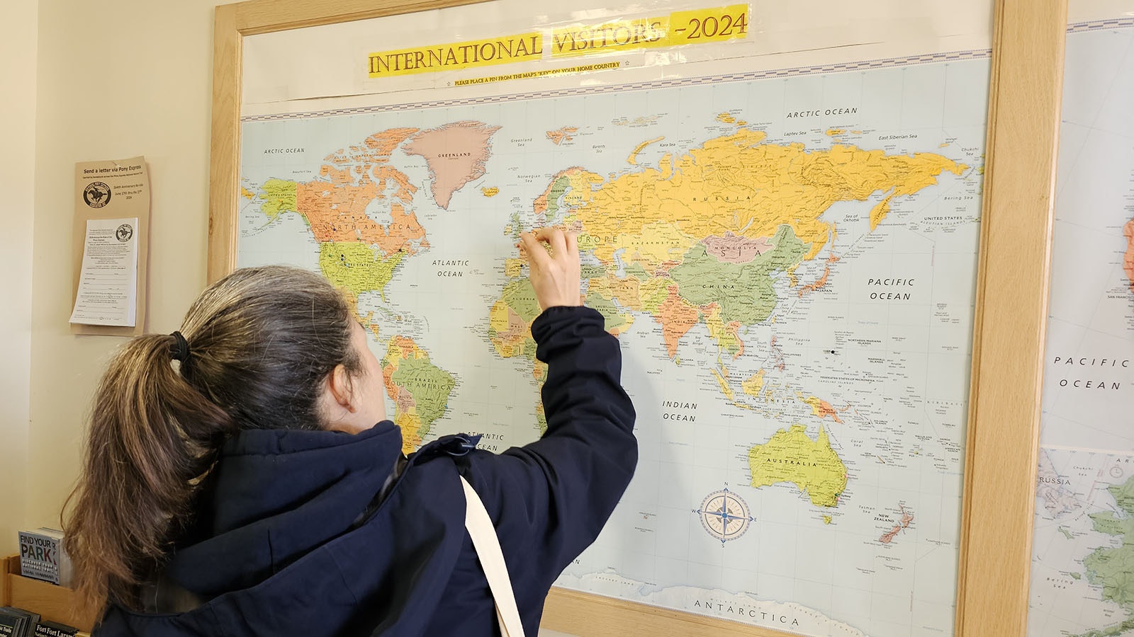 An international tourism agent puts a pin on the 2024 map at the Fort Caspar Museum on Saturday as part of the International Roundup, which brought agents from Europe and Australia to learn about tourism venues in the West.