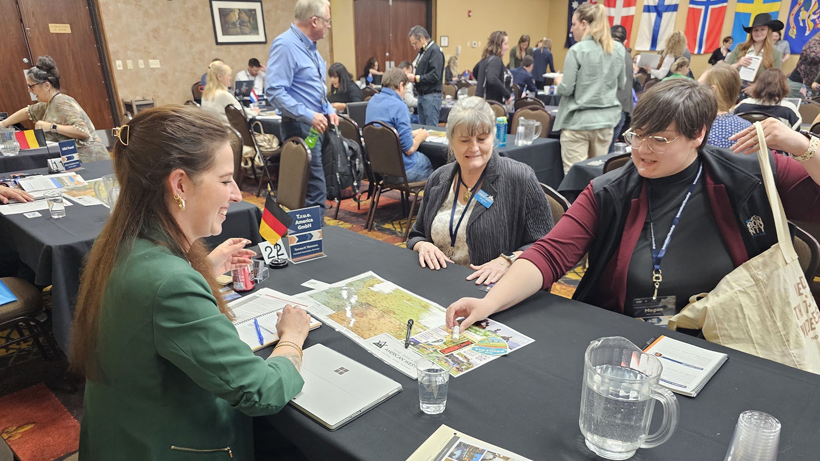 Visit Carbon County Sales and Marketing Coordinator Megan McComas, right. offers Tamara Tommers with German-based TRUE America a chapstick before beginning her pitch on tourism opportunities in Carbon County, while Visit Carbon County CEO Leslie Jefferson looks on.
