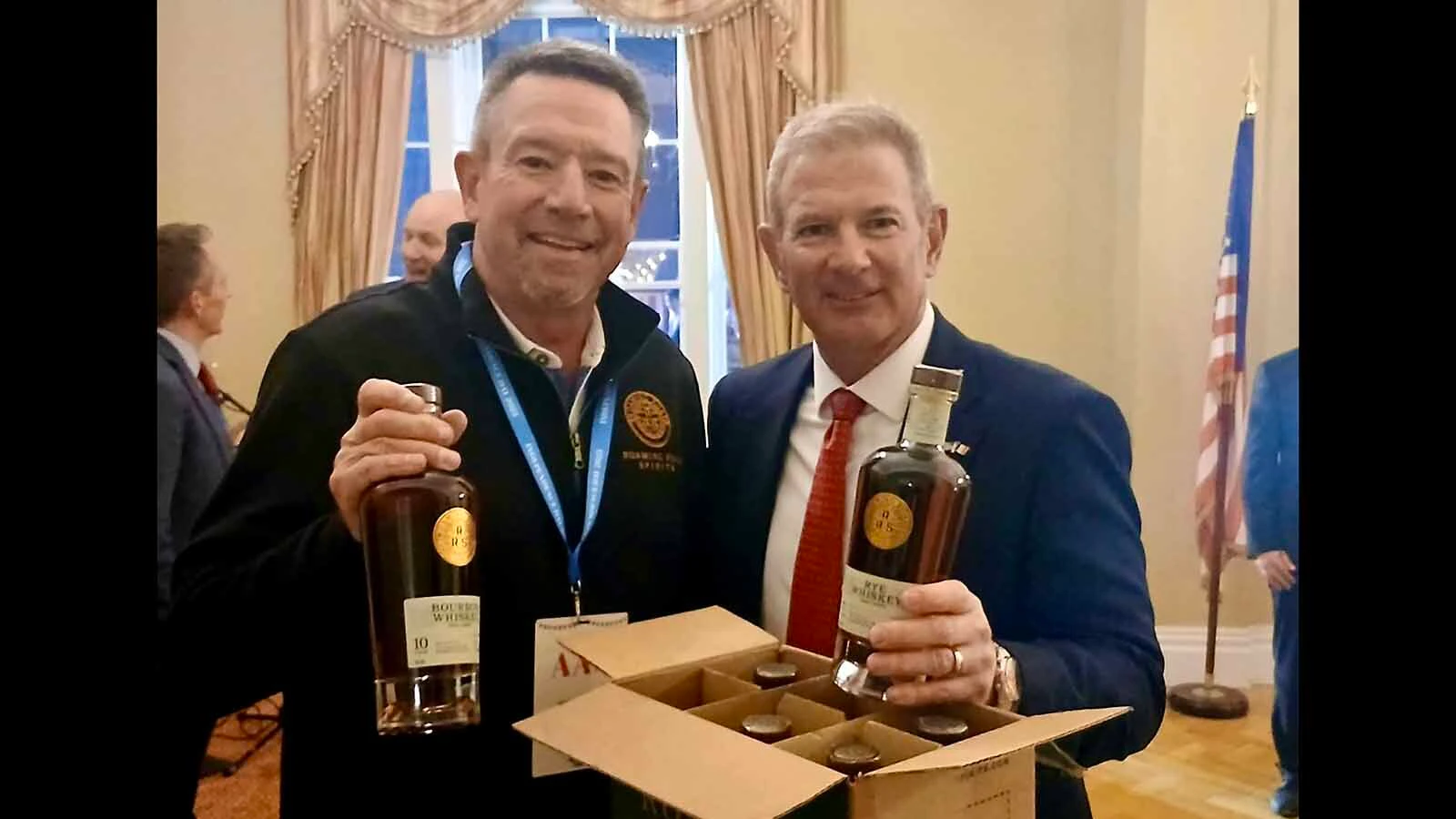 Mike Gilmore, left, with Corkscrew Spirits owner Thomas Sutton, show off the Roaming Roads label. 