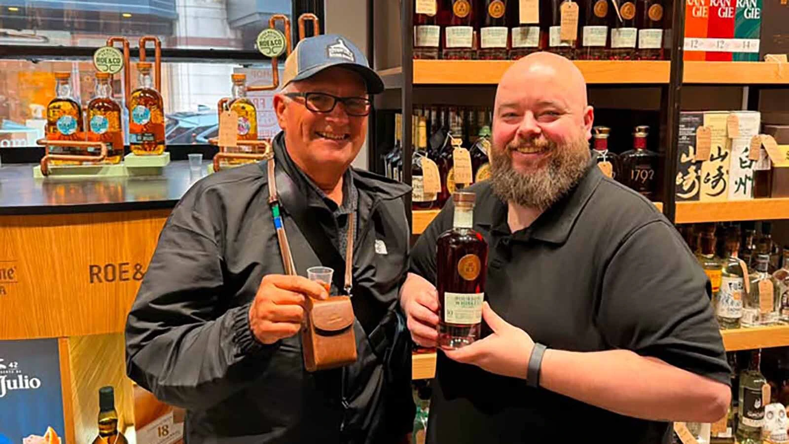 Dave Bell, left, with Corkscrew Spirits owner Thomas Sutton, show off the Roaming Roads label.