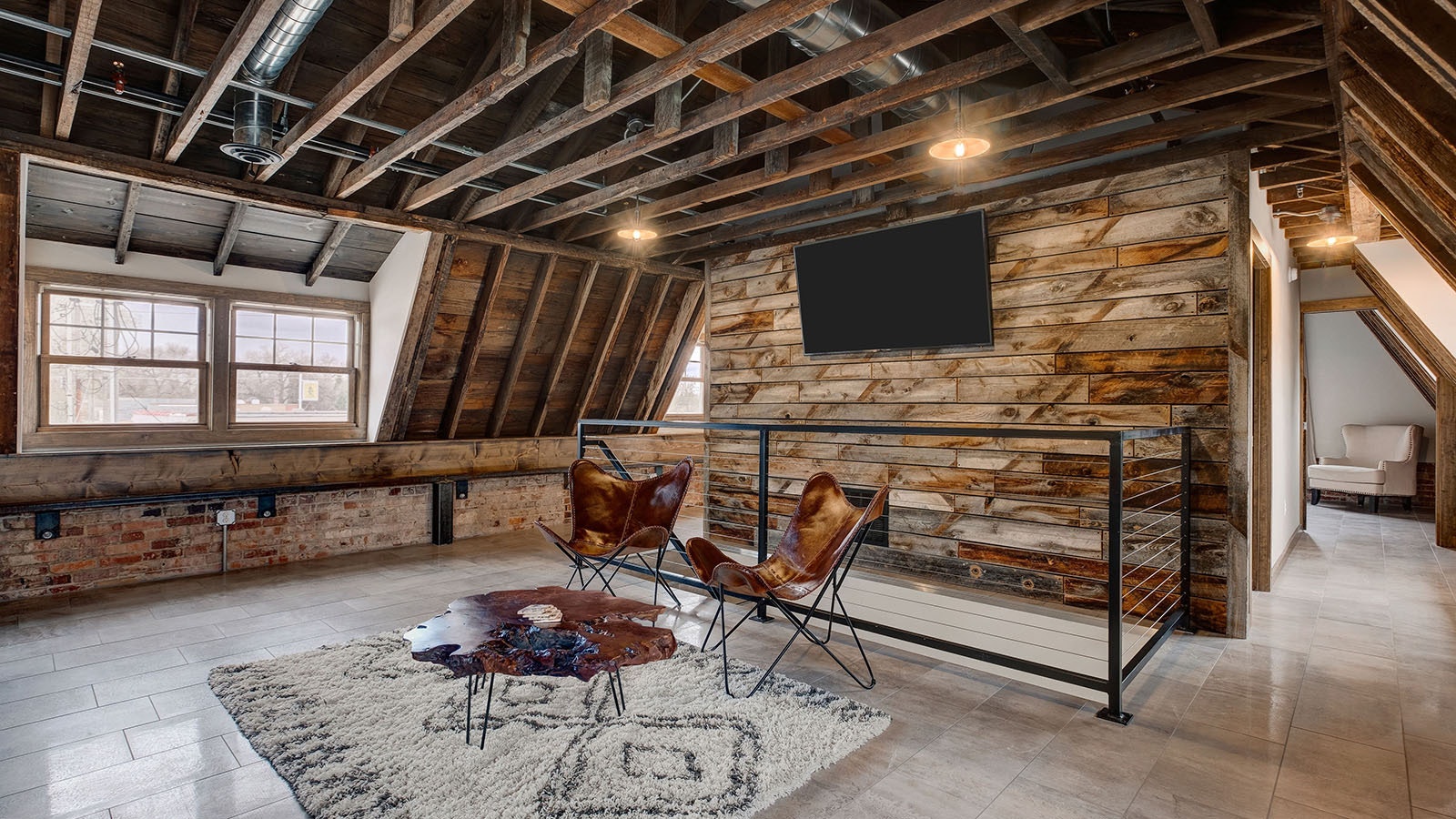 The loft of the Irwin Barn has been made into a comfortable, modern — yet still rustic — space.