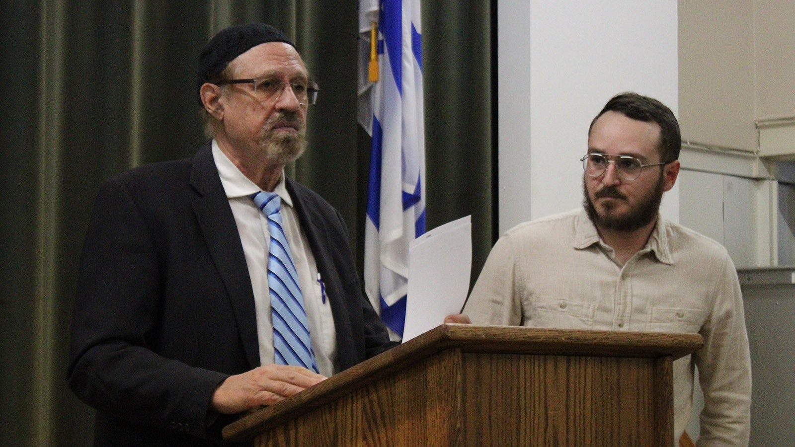 Mt. Sinai Rabbi Moshe Halfon (left) and Matani Ravenna speak during a vigil to mark the first anniversary of the Israel-Hamas war at Mt. Sinai Synagogue on Monday night, Oct. 7, 2024.