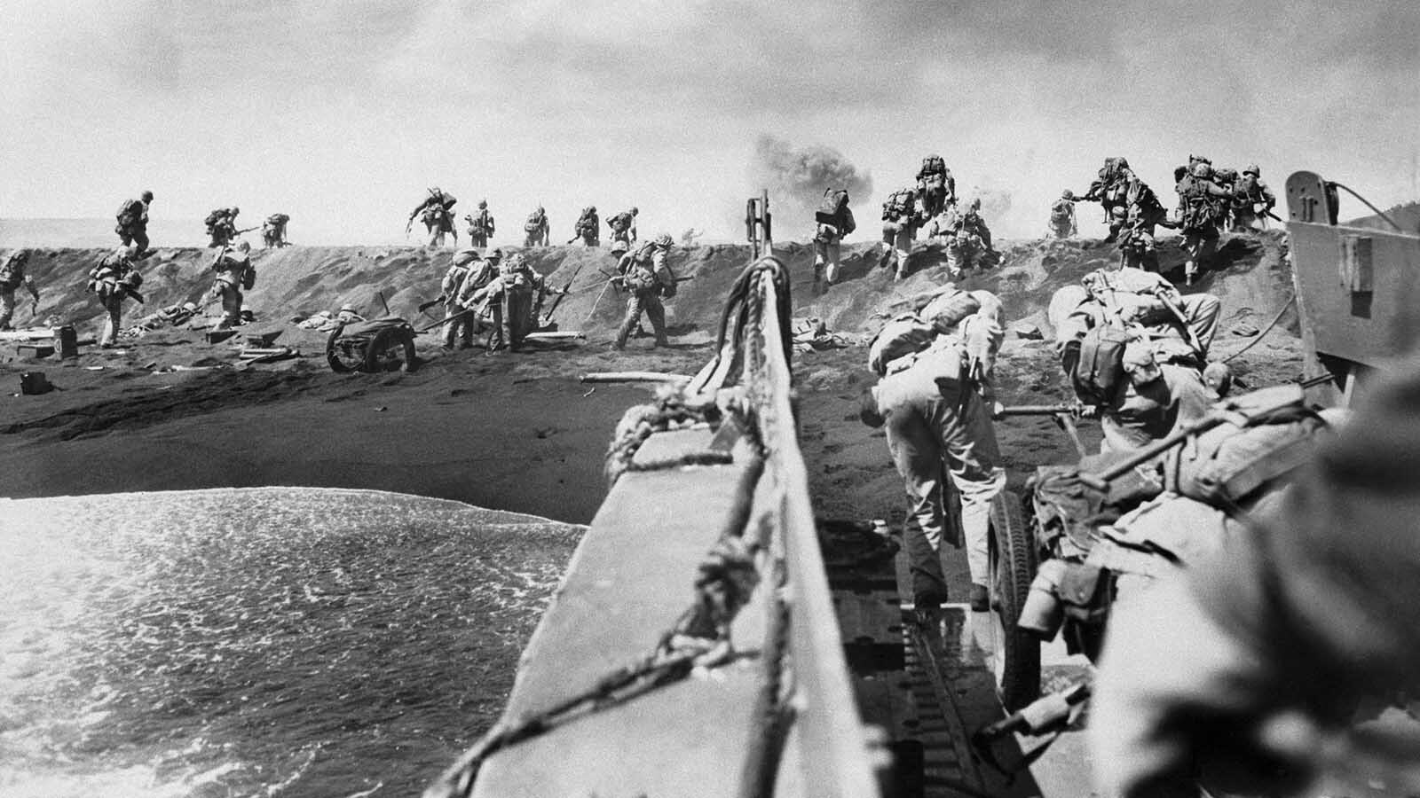 U.S. soldiers storm a beach on Iwo Jima during the Battle of Iwo Jima.