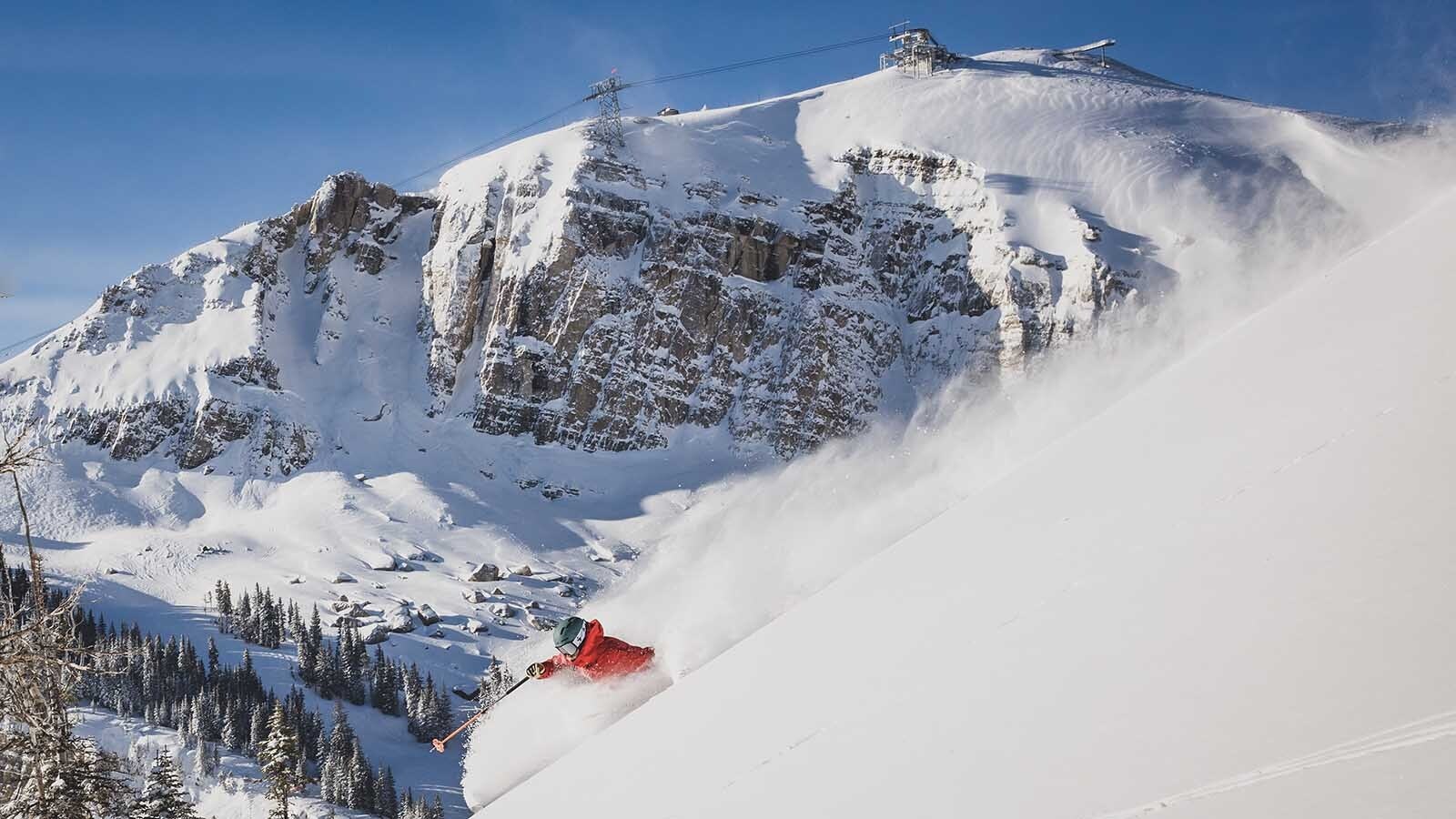 Wyoming ski resorts have put off their openings over a lack of snow, and conditions are a far cry from during the peak of last winter, shown here with a skier enjoying fresh powder at Jackson Hole Mountain Resort.