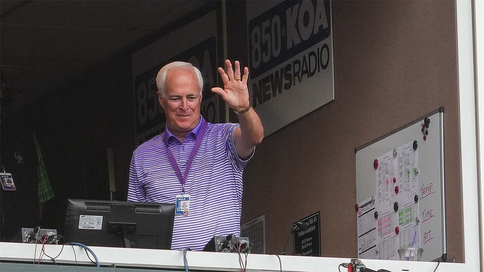 Longtime Colorado Rockies announcer Jack Corrigan waves to fans as they show their appreciation for him call his 3,000th Rockies game in May 2022.
