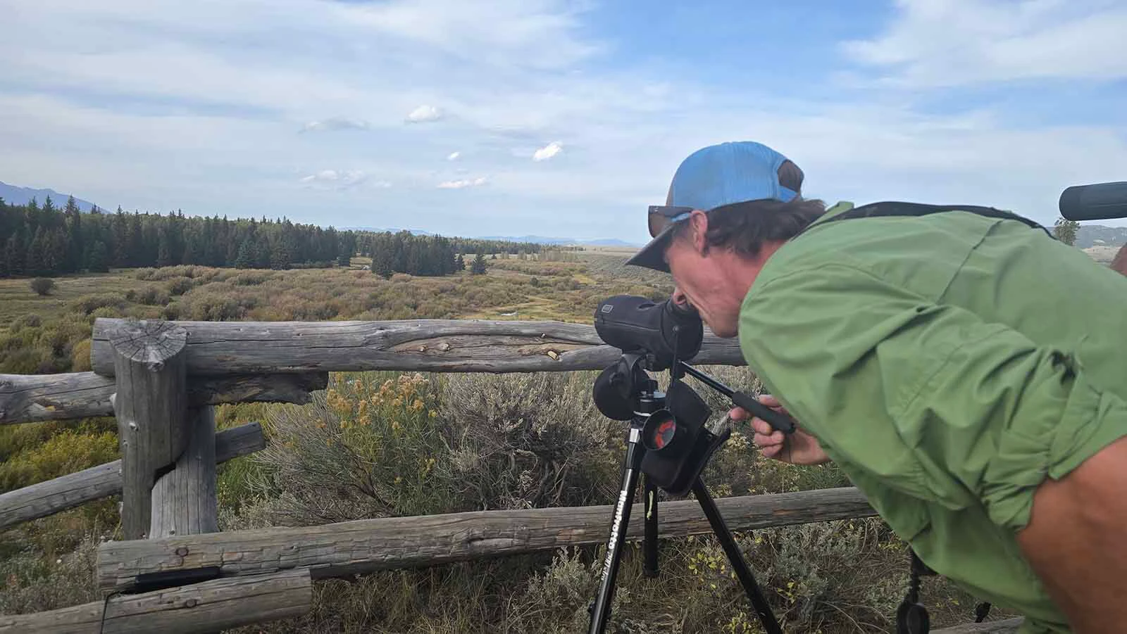 Wildlife expert Tyler Griffin peers through a spotting scope. Moments later he'd zeroed in on a mama moose.