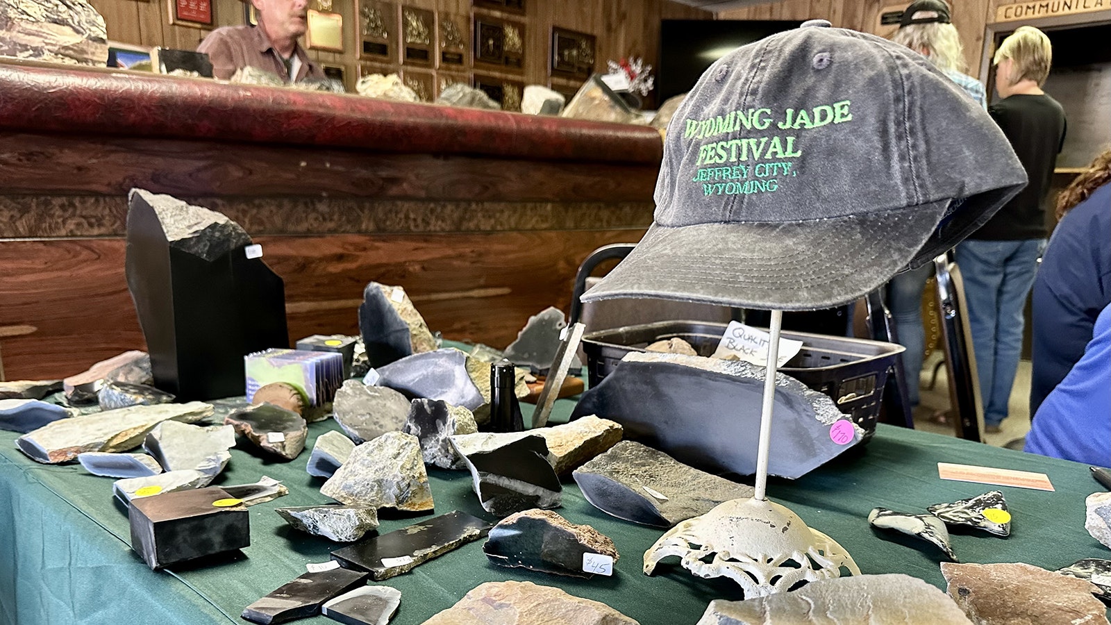 : A Wyoming Jade Festival ballcap among several Wyoming jade samples. Wyoming jade is considered to be some of the finest in the world, and there have been land claims for jade mining as recently as 2018.