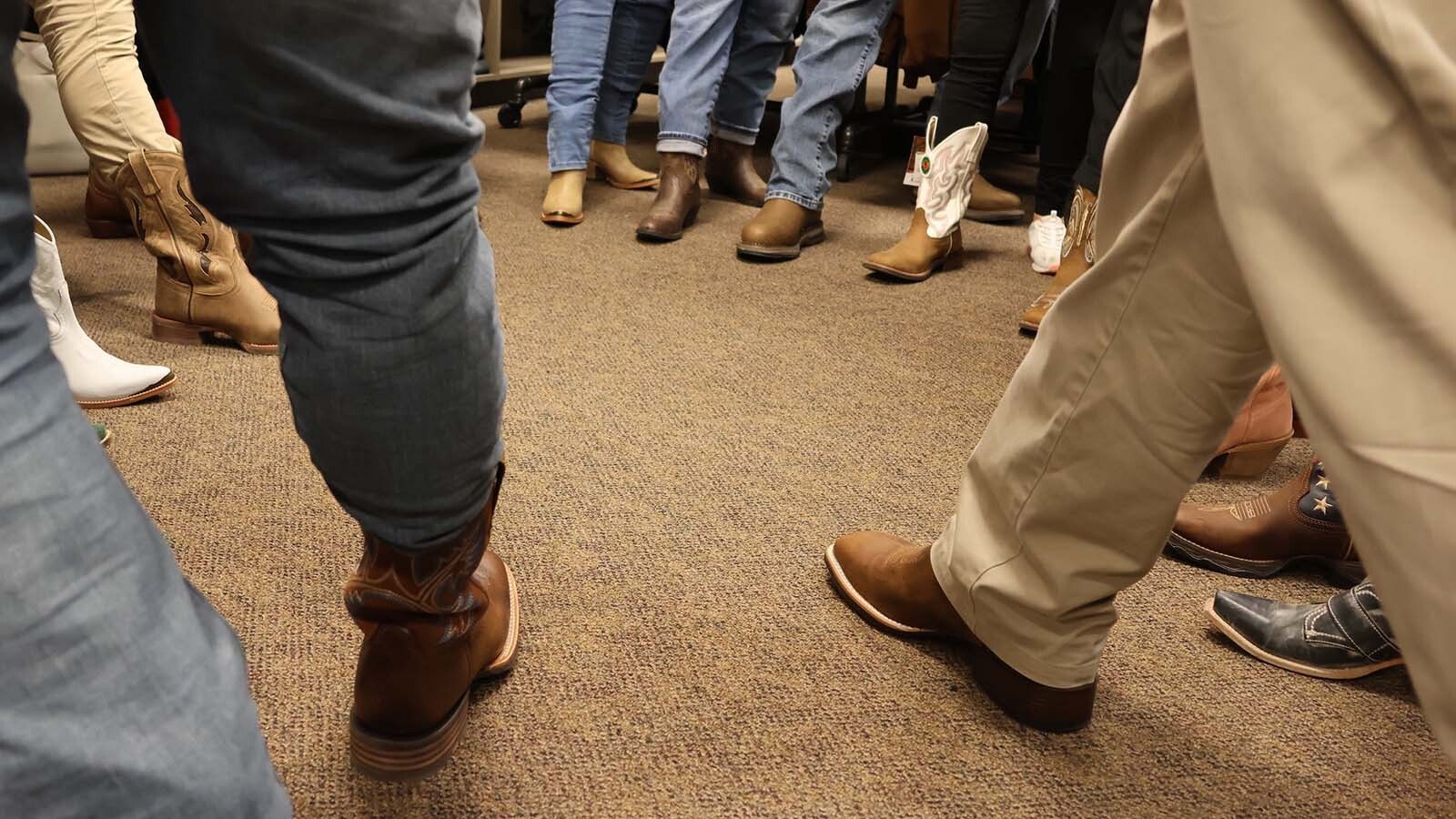 School officials and community members put their recently gifted “Jae Boots” in a circle at the Casper Boot Barn. Those gifted with the boots committed to doing regular mental health “boot checks” on themselves and others.