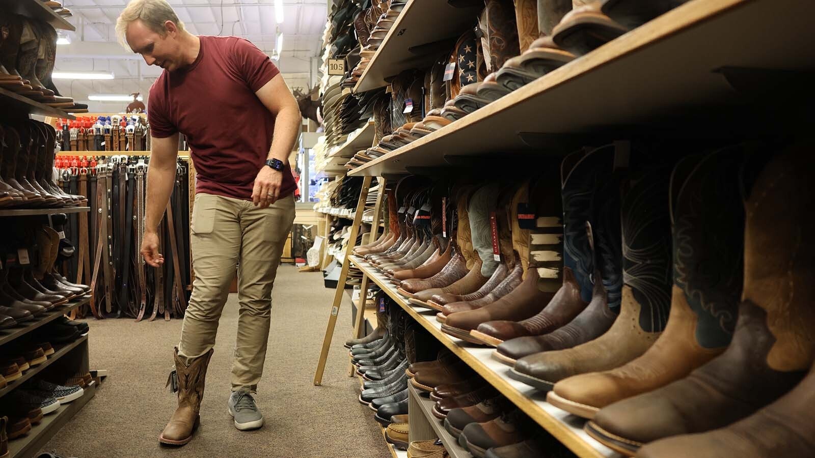 Natrona County Board of Education Trustee Thomas Myler looks for the right pair of “Jae Boots.” He said he was hesitant to get a pair, not wanting to take then until the message hit home that they are meant to promote conversations and “boot checks” with others about their mental health. He plans to use them as a reminder for conversations.