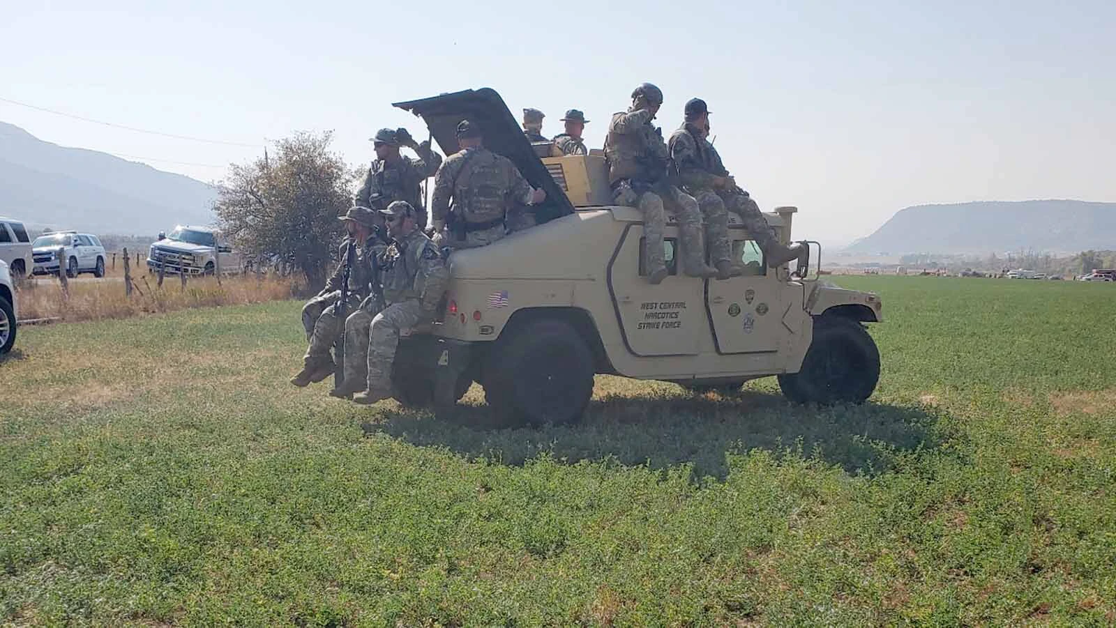 A tactical team heads into a rural Utah field during a fugitive operation that grew into a multi-agency law enforcement response.