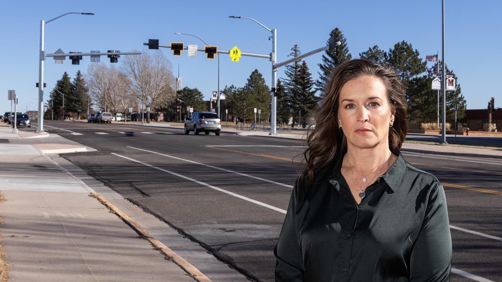 Janelle Jones stands in front of the new HAWK crossing at McCormick Junior High in Cheyenne installed in memory of her son, Mak. Janelle and her charity forMak helped get the new crossing built where her son Makaili “Mak” Evans, was hit by a car and killed in 2021.