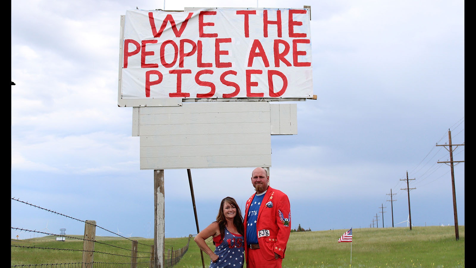 Jeanette and Andrew Kahler of Cheyenne stand under the 25-foot sign they put up on their property along Interstate 80.