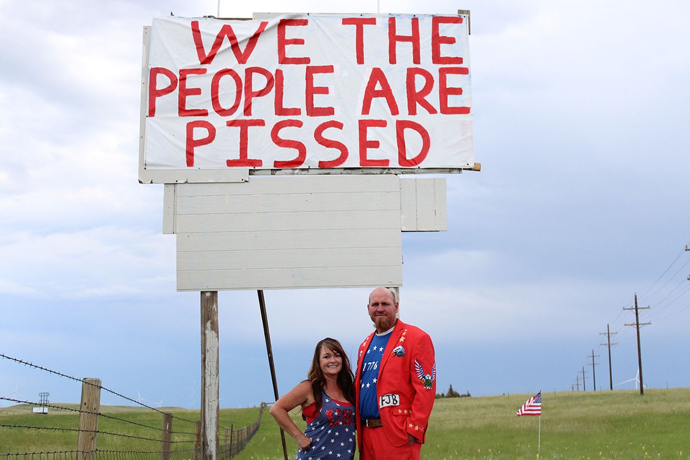 Jeanette and Andrew Kahler of Cheyenne stand under the 25-foot sign they put up on their property along Interstate 80.