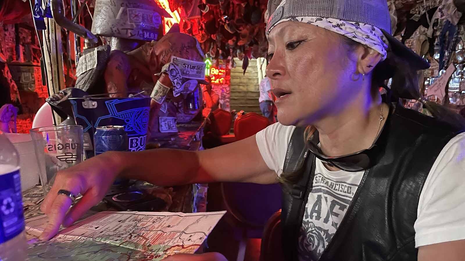 Jennifer Dyke maps her next ride at the Dungeon Bar in Sturgis, South Dakota.