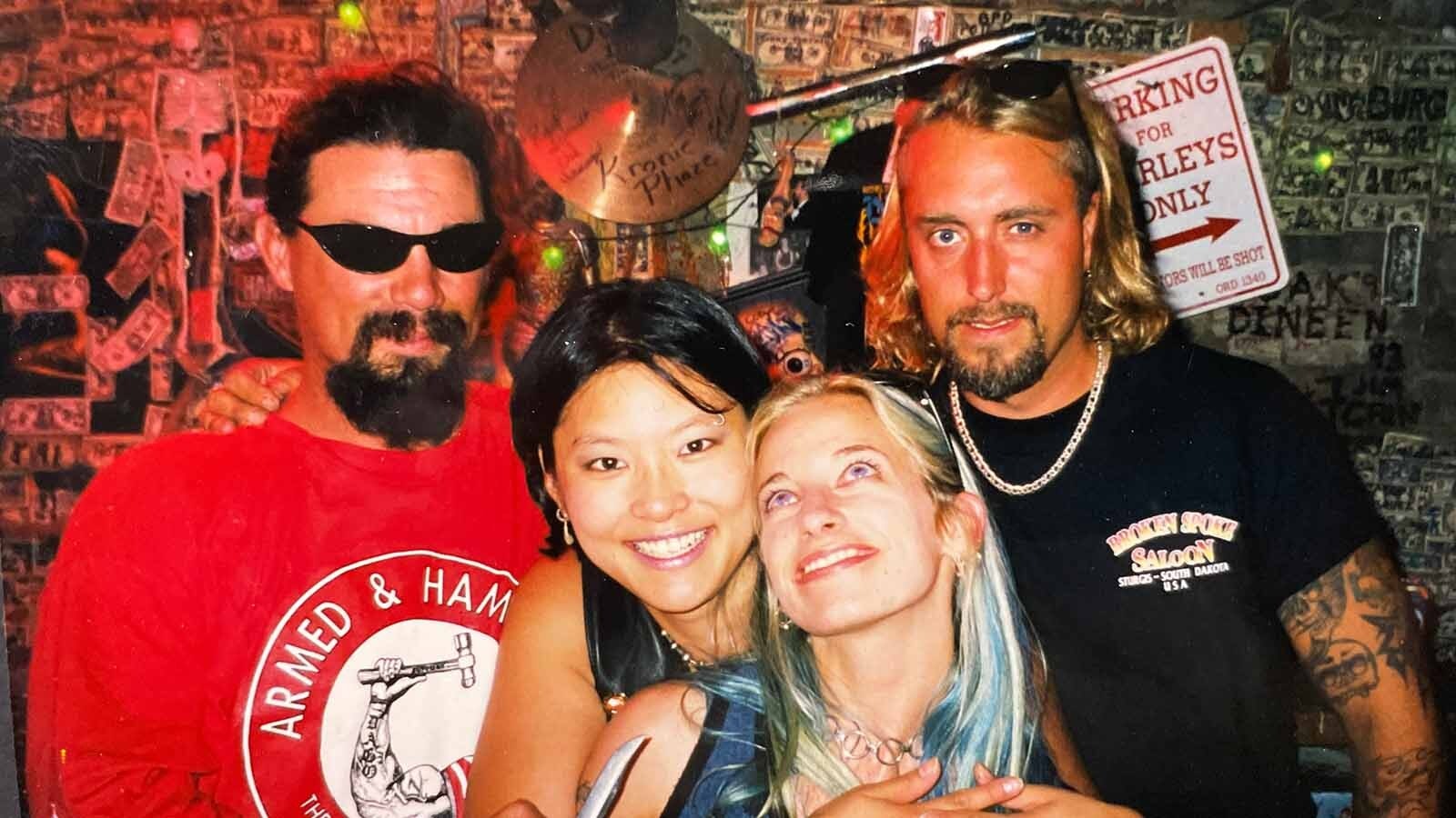 It wasn't until after the film was developed that Jennifer Dyke realized one of the guys photobombing this picture with a friend was holding a knife pointed at them.