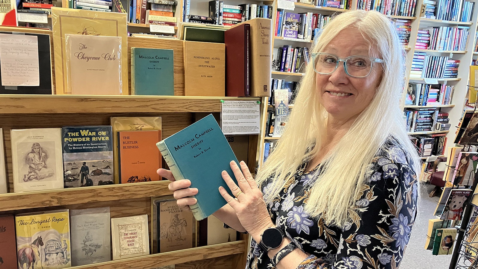 Jen’s Books owner Jen Pollock holds her favorite book from Wyoming history, a biography of Converse County Sheriff Malcolm Campbell.