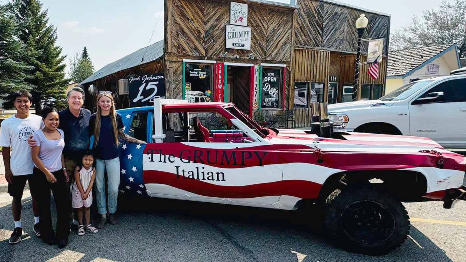 Jerahleigh Johnson stands beside her patriotic No. 15 Cadillac.