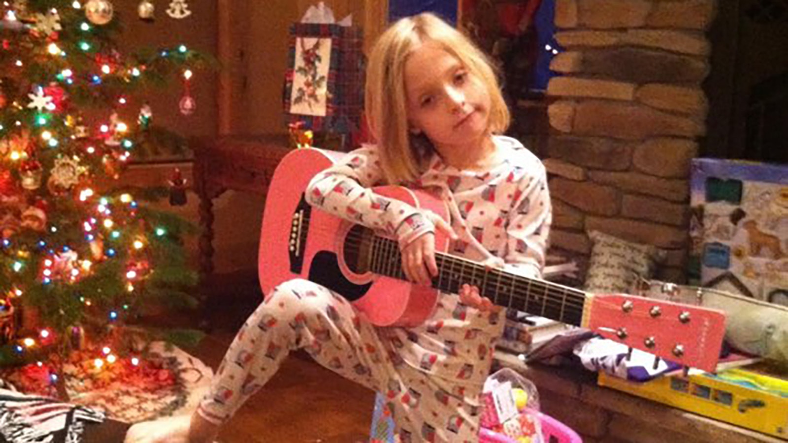 Jillian Nordberg with her first guitar on Christmas Day 2015. She was 6 years old.