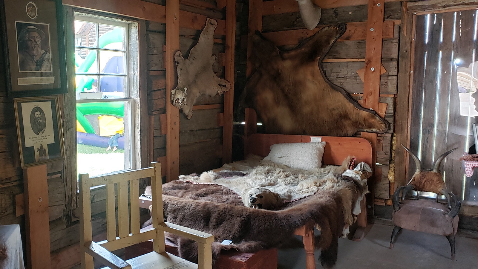 The furs of animals decorate the walls of Jim Baker's fortress cabin built in 1873.