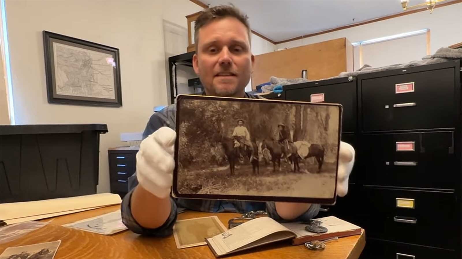 Paul Knowles shows a recently discovered photo of Jim Douglas, left, founder of Dixon, Wyoming, riding with famous mountain man Jim Baker.