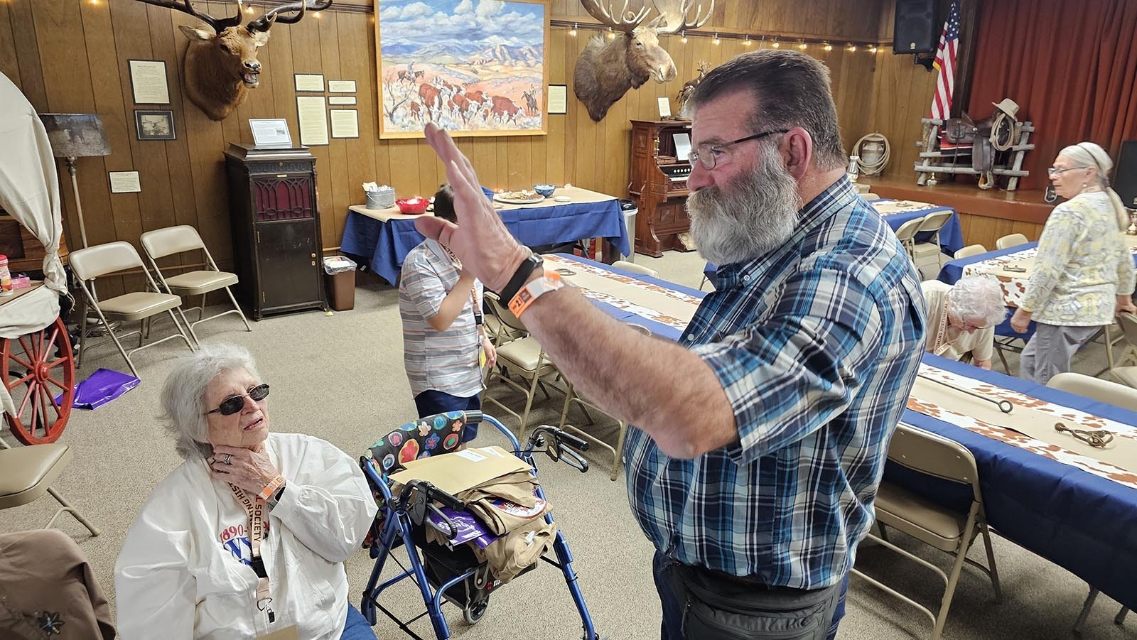 Carol Truesheim Waters, seated, listens to stories about Gebo at Hot Springs County Museum on Thursday.