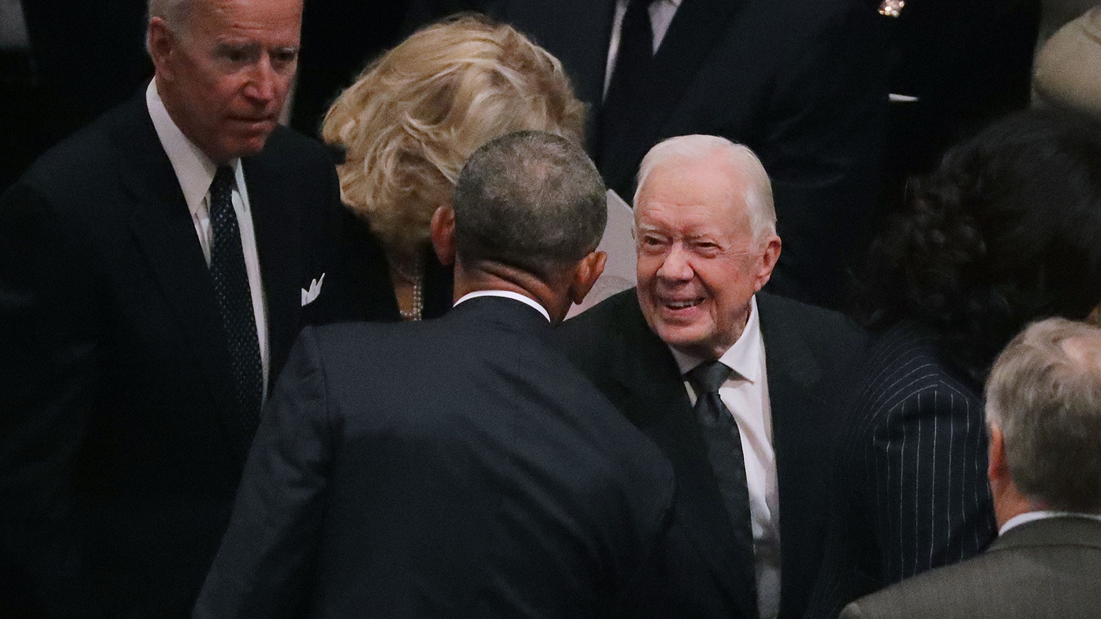 Former presidents Barack Obama and Jimmy Carter greet one another during the state funeral for former President George H.W. Bush at the National Cathedral Dec, 05, 2018, in Washington, D.C.