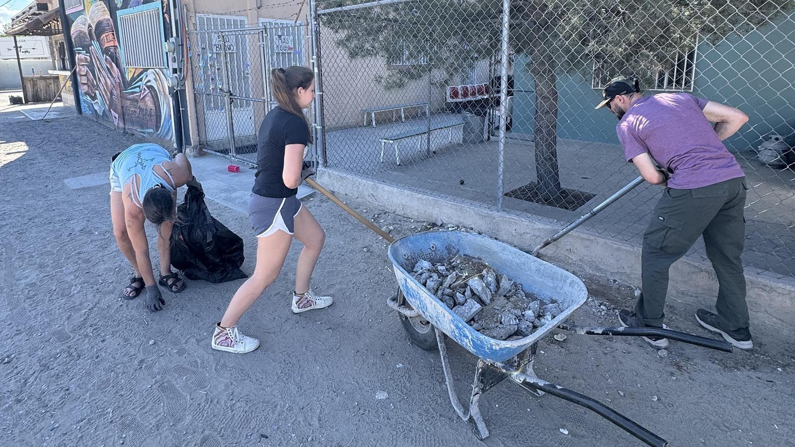 Members of the Wyoming team clean up around the church compound.