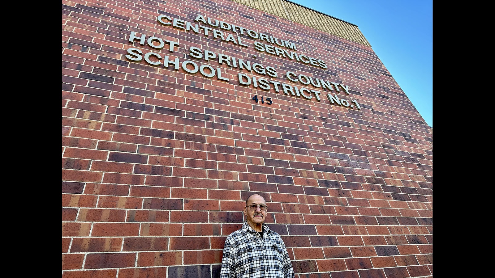 Joe Arnold in front of the building that will soon have his name on it.