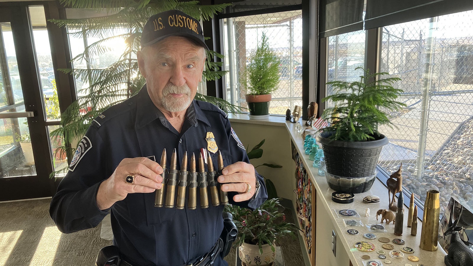 Dale Leatham holds some 50-caliber machine gun shells he found on airport property – the site of a World War II Army Air Corps base.