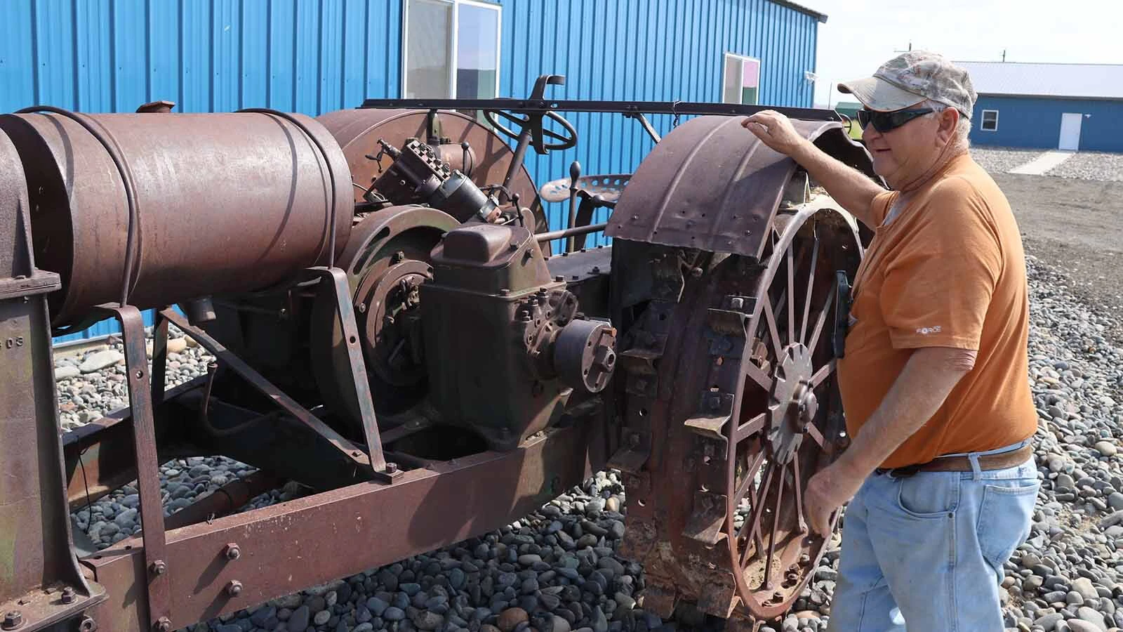 Pete Smet looks at his rarest tractor, a 1920 Hart Parr that has the engine installed sideways.