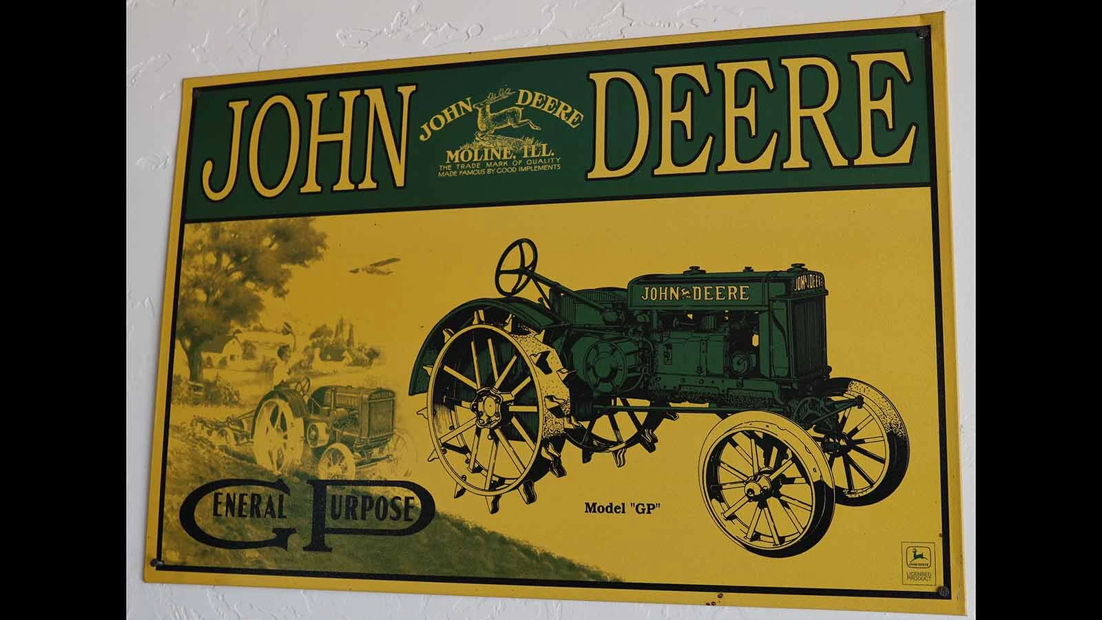 An old John Deere advertisement for the general purpose tractor hangs on a wall in Pete Smet’s garage. 