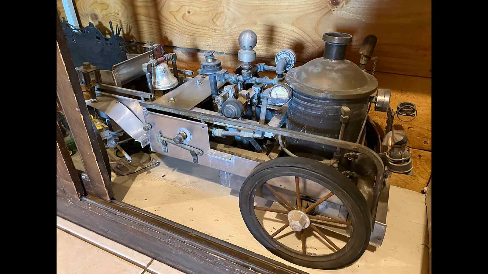An old model steam engine sits in a cabinet in Pete Smet’s office.