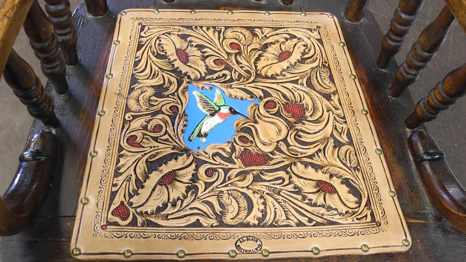 A leather seat for a rocking chair made by wyoming leatherworker and saddlemaker John L. Blair.