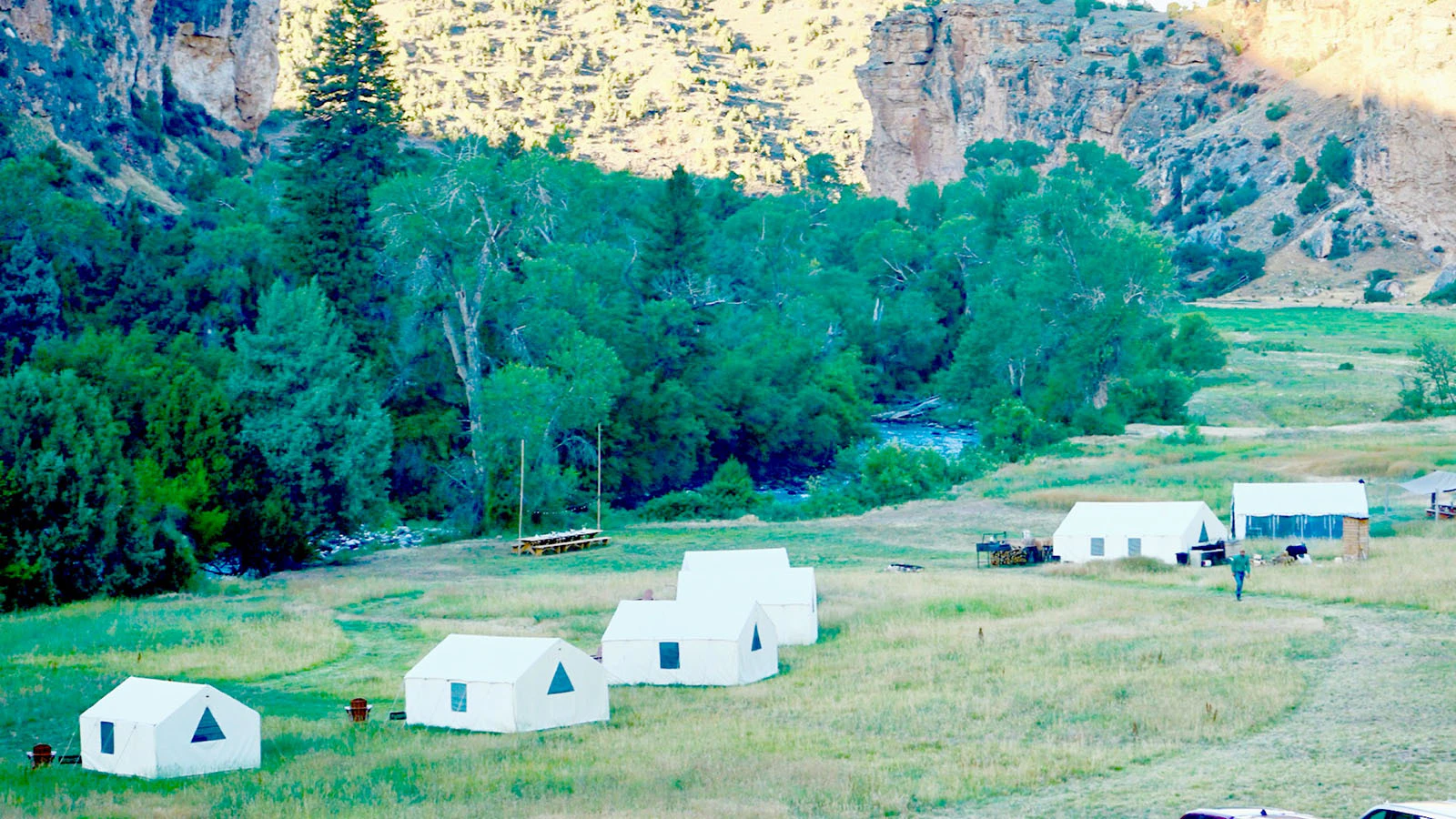 Canvas tents along Paintrock Creek served as camp for a group of old friends during their horseback reunion in Wyoming.
