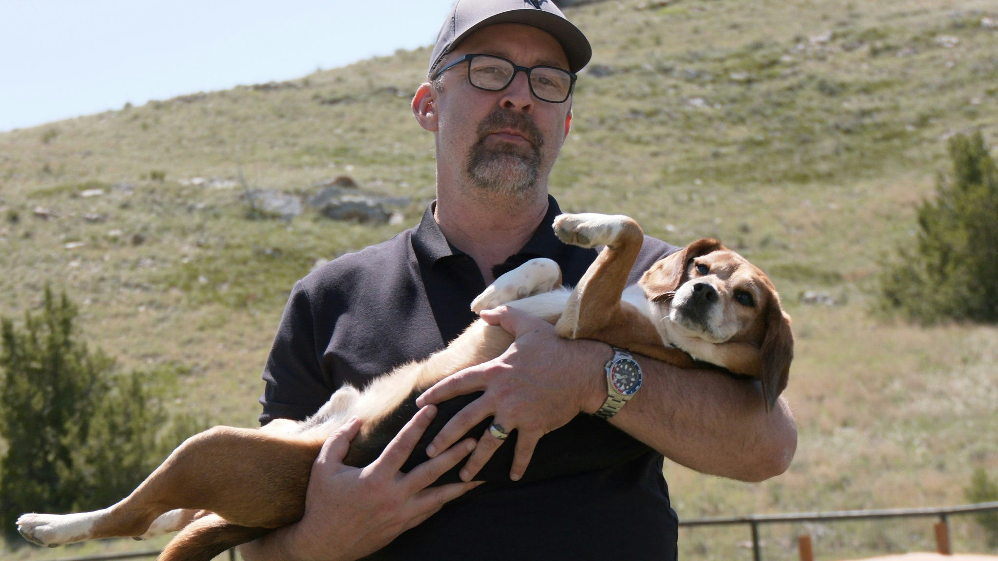 Kindness Ranch Executive Director John Ramer holds Snow, a beagle who is a former research animal.