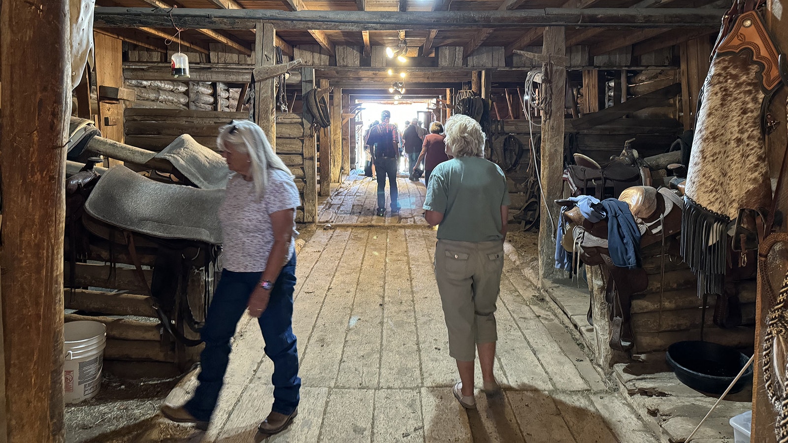 Visitors on the Johnson County War Tour inside the barn at the TA Ranch. The invaders barricaded themselves inside this barn and were besieged by a posse of 200 Johnson County residents for three days until they were incarcerated by the U.S. Army on April 13, 1892.