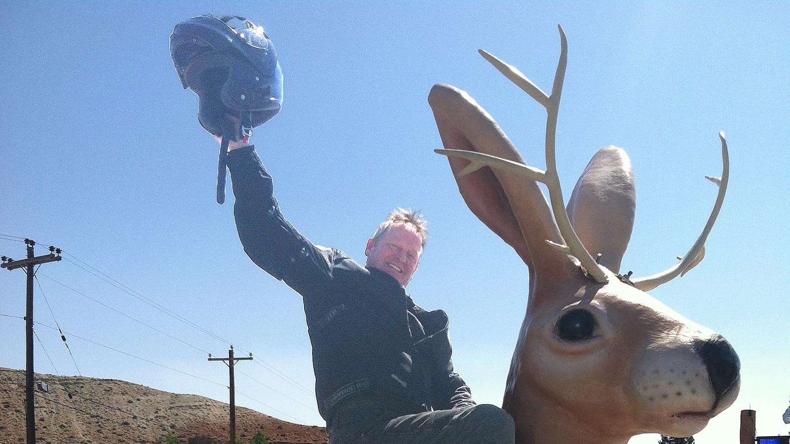 Wyoming author Craig Johnson whoops it up on the back of a giant jackalope.