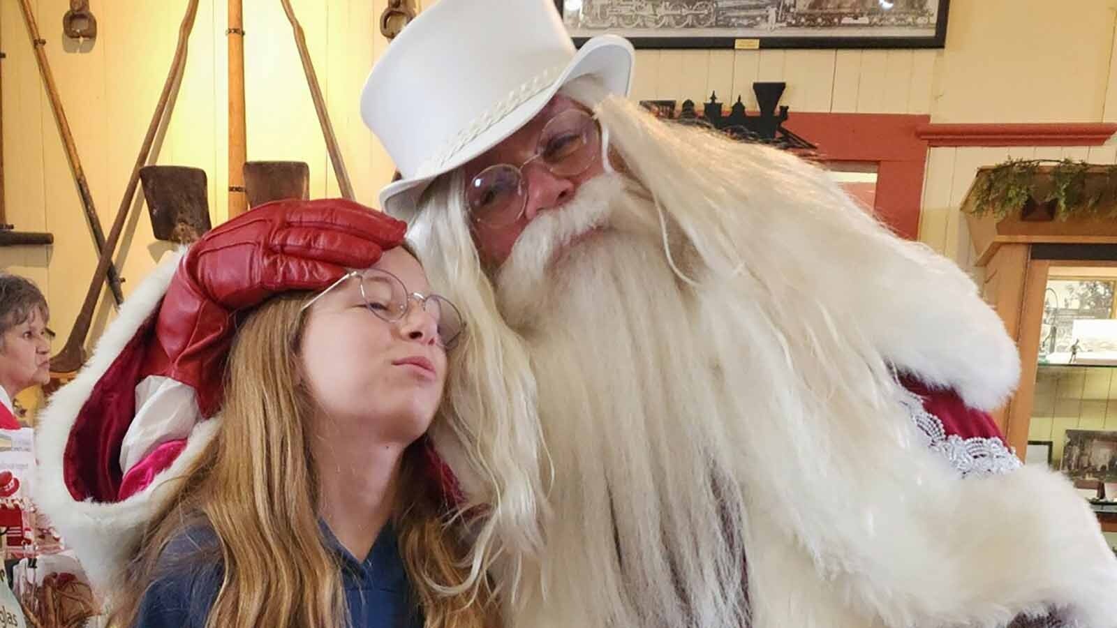 The Jolliest Claus and a young fan pose for season photo at the Douglas Depot.