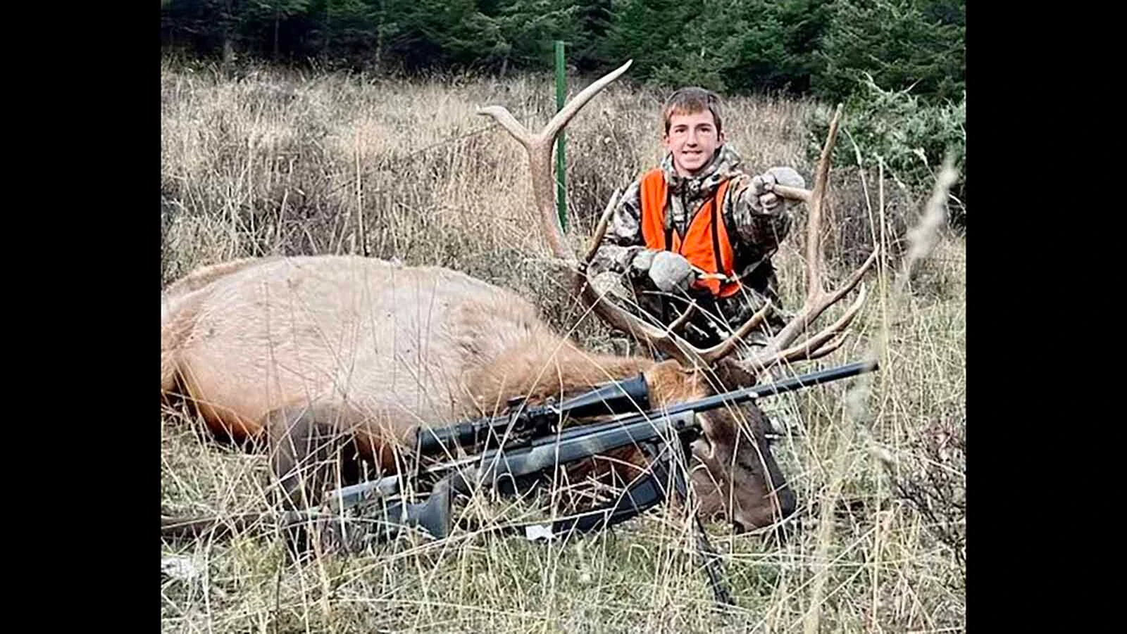 Jory Thomas, 14, poses with a bull elk he harvested during a Montana hunt. His father describes him as an avid outdoorsman who enjoys hunting, ranching and spending time horseback.
