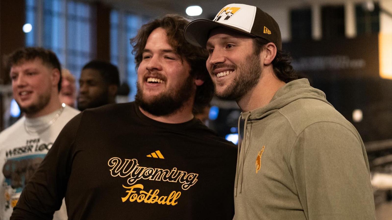 Former University of Wyoming quarterback, and reigning NFL MVP, Josh Allen visits with current UW football players Friday night after arriving in Laramie ahead of Saturday's halftime ceremony to retire his No. 17 jersey.