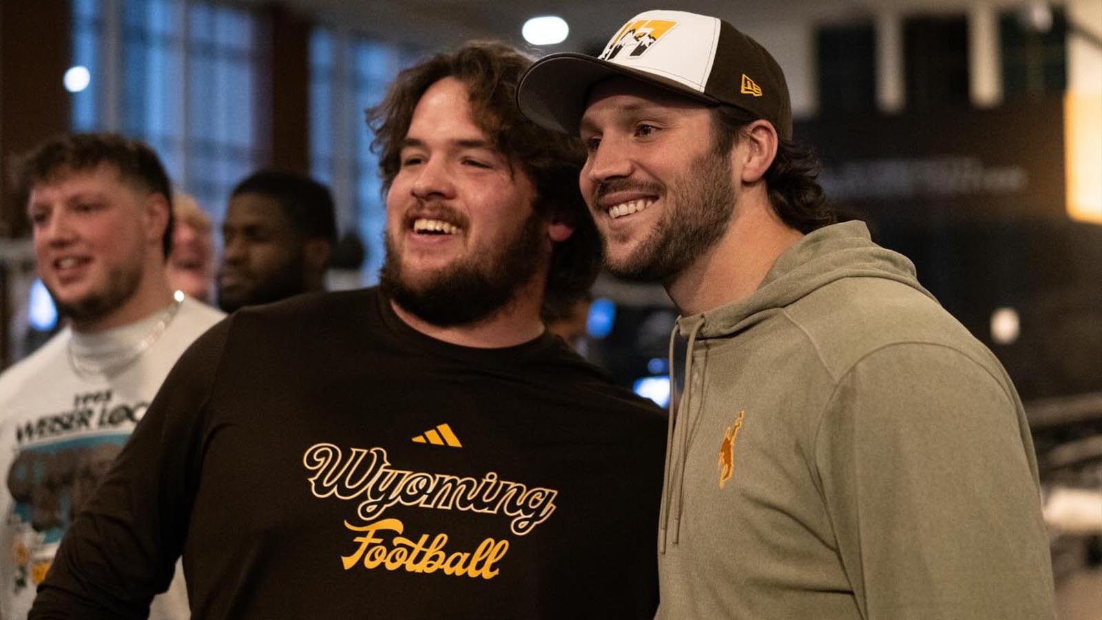 Former University of Wyoming quarterback, and reigning NFL MVP, Josh Allen visits with current UW football players Friday night after arriving in Laramie ahead of Saturday's halftime ceremony to retire his No. 17 jersey.