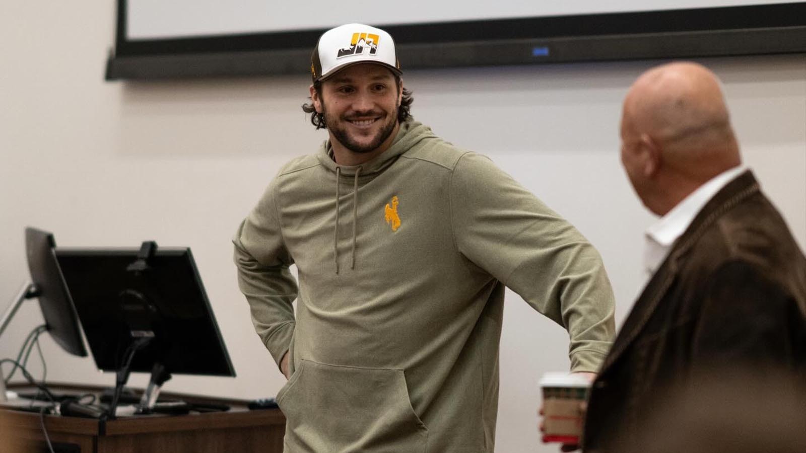 Former University of Wyoming quarterback, and reigning NFL MVP, Josh Allen visits with current UW football players Friday night after arriving in Laramie ahead of Saturday's halftime ceremony to retire his No. 17 jersey.