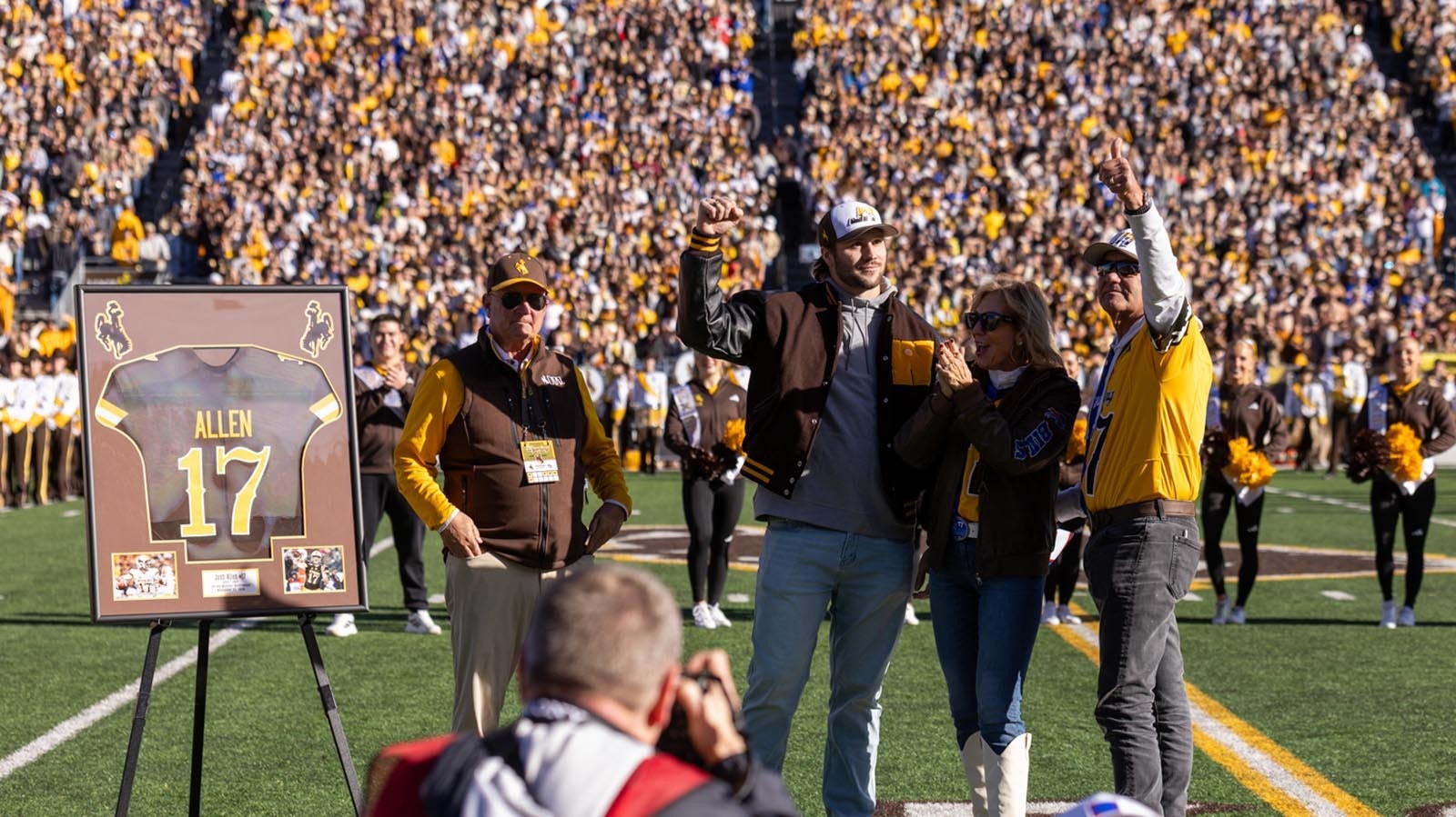 Former University of Wyoming quarterback Josh Allen at midfield during halftime of Saturday's Nov. 22, 2025, game against Nevada to have his No. 17 retired. He's seen here with, from left, former UW head coach Craig Bohl, and his parents, LaVonne and Joel Allen.