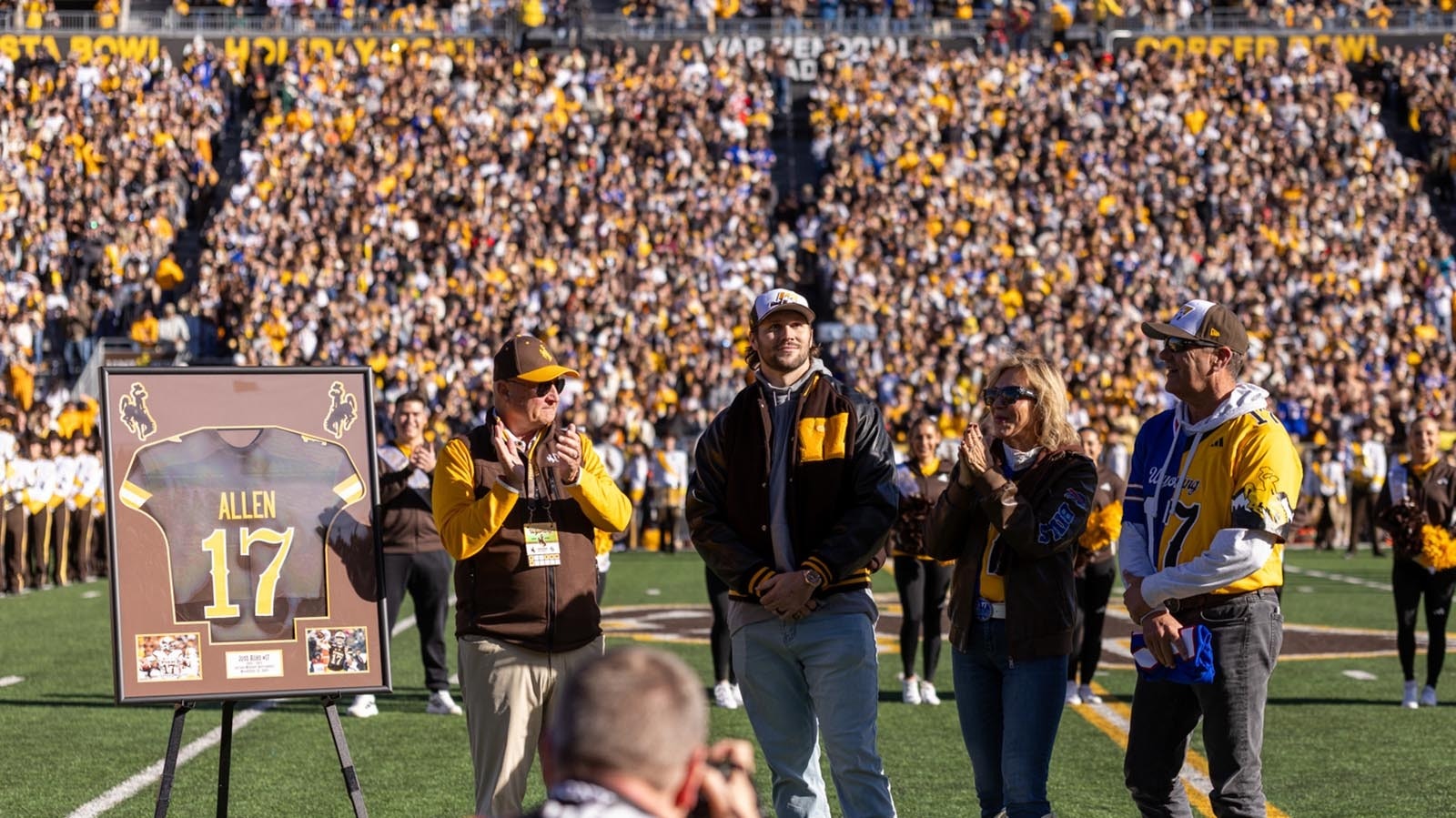 Former University of Wyoming quarterback Josh Allen at midfield during halftime of Saturday's Nov. 22, 2025, game against Nevada to have his No. 17 retired. He's seen here with, from left, former UW head coach Craig Bohl, and his parents, LaVonne and Joel Allen.