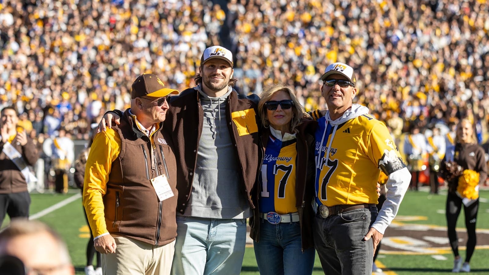 Former University of Wyoming quarterback Josh Allen at midfield during halftime of Saturday's Nov. 22, 2025, game against Nevada to have his No. 17 retired. He's seen here with, from left, former UW head coach Craig Bohl, and his parents, LaVonne and Joel Allen.