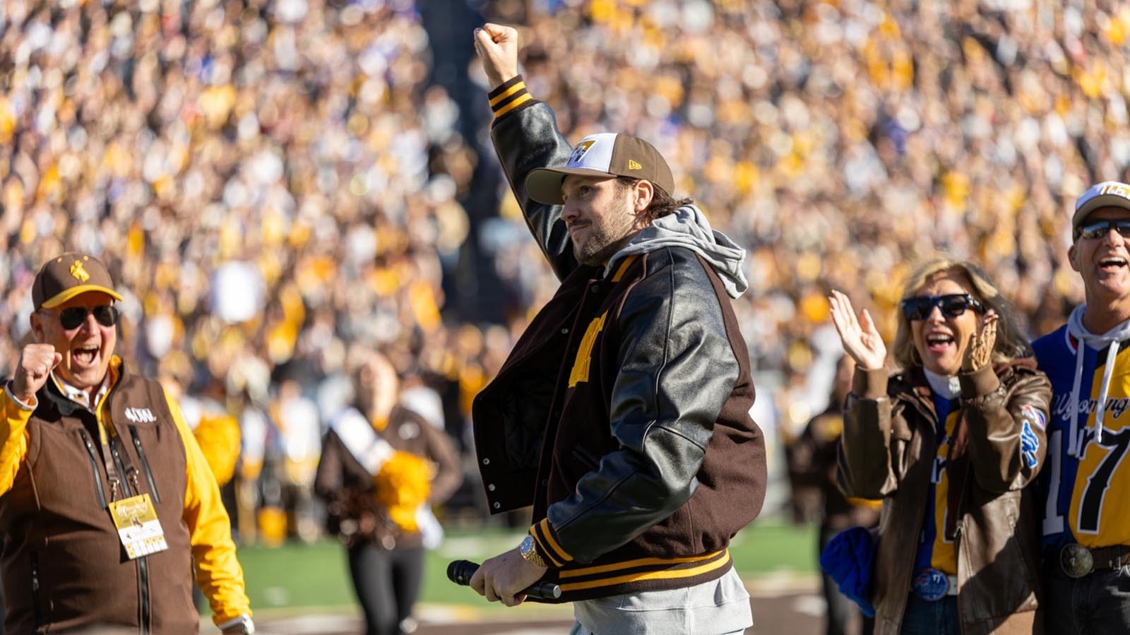 Former University of Wyoming quarterback Josh Allen at midfield during halftime of Saturday's Nov. 22, 2025, game against Nevada to have his No. 17 retired. He got a huge ovation from the crowd, especially when he concluded his remarks with, "And it will always suck to be a CSU Ram!" Behind him is former UW head coach Craig Bohl, left, and his parents, LaVonne and Joel Allen.