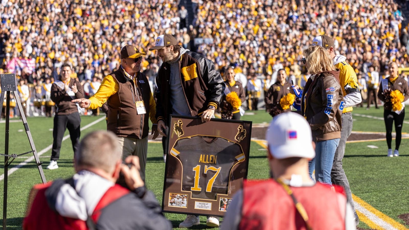 Former University of Wyoming quarterback Josh Allen at midfield during halftime of Saturday's Nov. 22, 2025, game against Nevada to have his No. 17 retired. He's seen here with, from left, former UW head coach Craig Bohl, and his parents, LaVonne and Joel Allen.