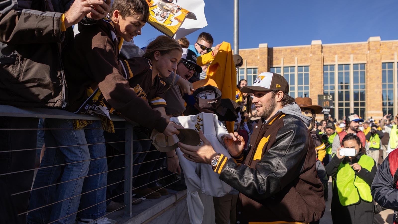 Former University of Wyoming star quarterback Josh Allen signs autographs for young fans before kickoff off the Cowboys' game against Nevada at War Memorial Statium in Laramie on Saturday, Nov. 22, 2025. Allen was back at UW for the first time since he was drafted into the NFL in 2018 to become the first UW football player to have his number retired.