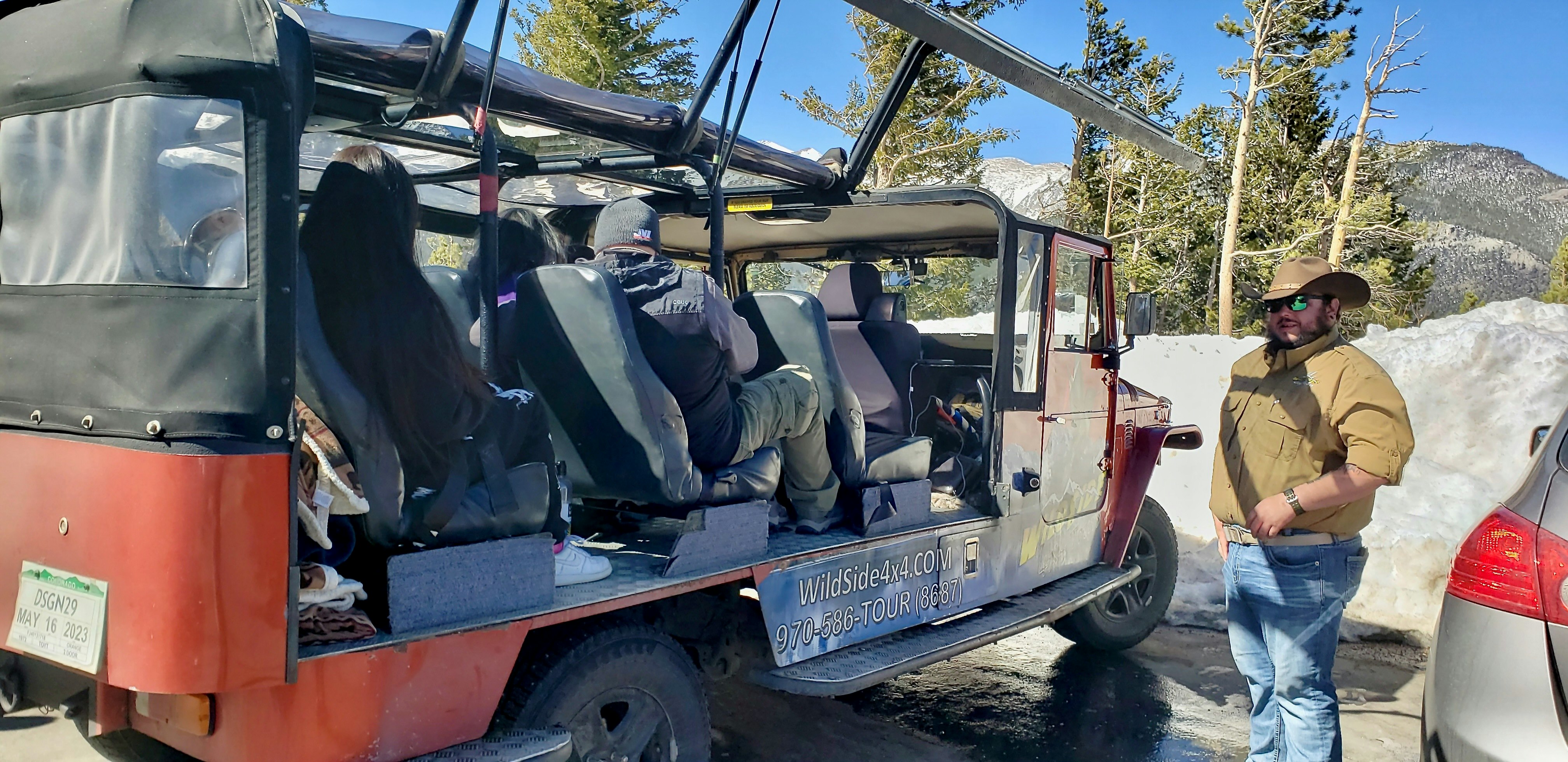 Josh waits patiently for tour participants to board the Wildsides custom designed 4x4 which has clear plastic windows all around for maximum sightline and photography
