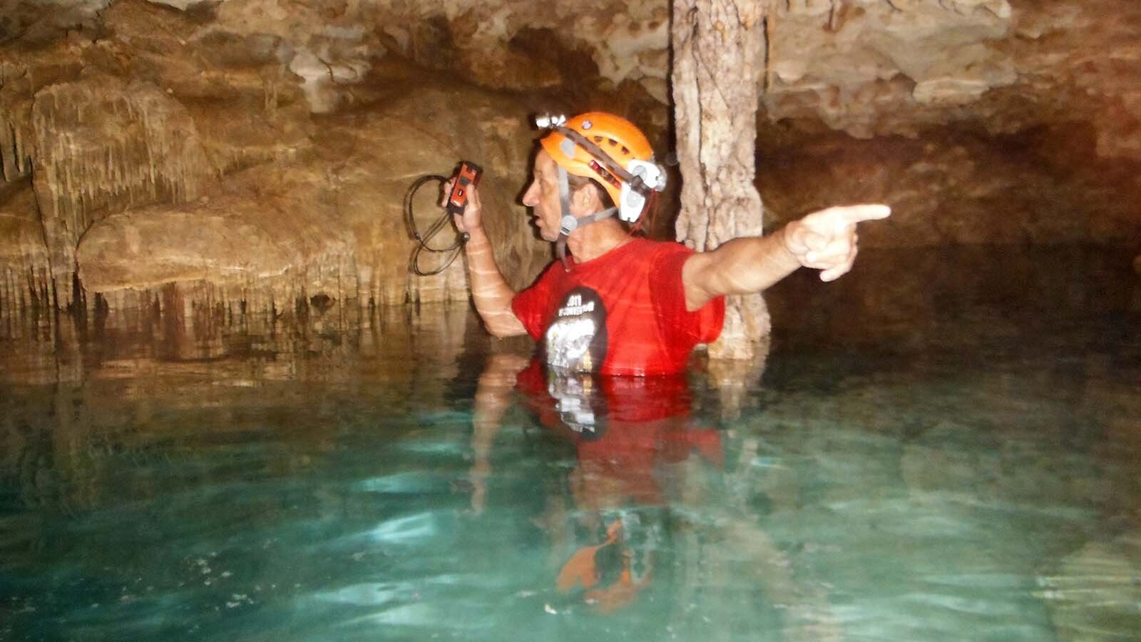 Juan Laden of Lander, Wyoming, surveying a cave with a team in Mexico.